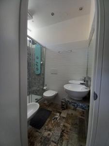 a bathroom with two sinks and a shower and two toilets at Atmos Luxe Navigli in Milan