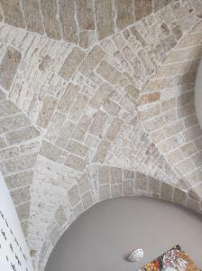um tecto de tijolos num quarto com uma parede de tijolos em Maison de Richard em Ostuni