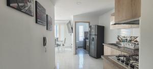 a kitchen with a stainless steel refrigerator in a room at Lujoso LOFT en el Centro in Cartago