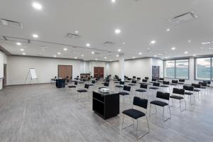 a large room with rows of chairs and tables at City Express by Marriott Queretaro in Querétaro