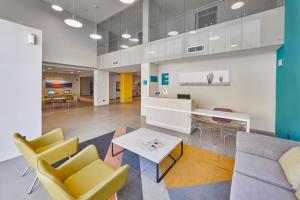 a lobby with chairs and a couch and a table at City Express Suites by Marriott Silao Aeropuerto in Silao