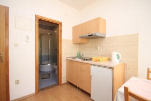 a small kitchen with a sink and a toilet at Apartments by the sea Kastel Kambelovac, Kastela - 8627 in Kaštela
