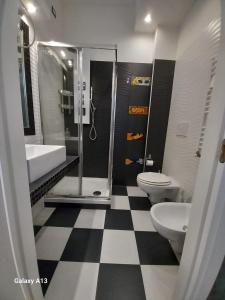 a bathroom with two toilets and a sink and a shower at Atmos Luxe Navigli in Milan
