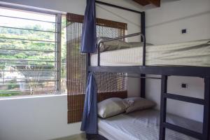 two bunk beds in a room with a window at AREA 51 HOSTEL in Medellín