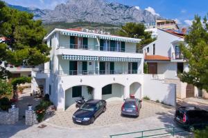a white house with two cars parked in front of it at Studio Promajna 2592a in Promajna +12 photos