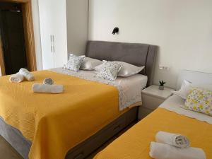 a bedroom with two beds with towels on them at Studio Promajna 2592a in Promajna