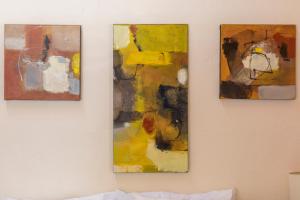 three paintings are hanging on a wall at Meztli: Casa Boutique & Spa in Mexico City