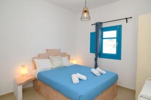 a bedroom with a bed with two towels on it at levante studios 2 in Amorgos +5 photos