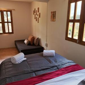 1 dormitorio con 1 cama grande y 2 almohadas en Guayacan Alojamiento, en Santa Elena