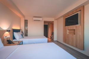 Cama o camas de una habitación en Lyz Business Hotel Piura
