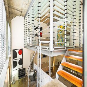 a staircase leading up to a room with wine racks at WAREHOUSE RARE!! MASSIVE LUXURY ARCHITECTURAL MASTERPIECE w HUGE PRIVATE ROOFTOP GARDEN WITH PANARAMIC CITY VIEWS in Sydney
