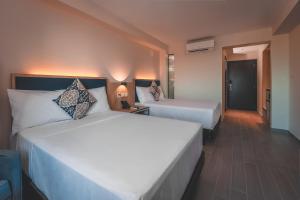 Cama o camas de una habitación en Lyz Business Hotel Piura
