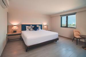 Cama o camas de una habitación en Lyz Business Hotel Piura