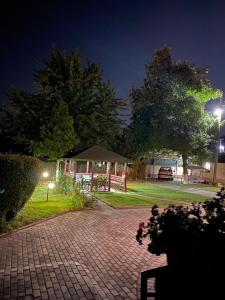a gazebo with a tent in a yard at night at Villa Magnifica in Strumica