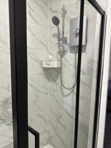 a shower with a blow dryer in a bathroom at Juz Apartments Manchester airport in Altrincham