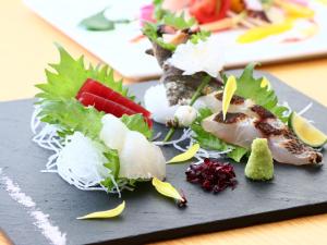a black plate with sushi and vegetables on a table at Kotsubokaigan Linca in Zushi +23 photos