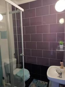 a bathroom with a toilet and a sink at Beach House Surfing Baleal Peniche in Baleal