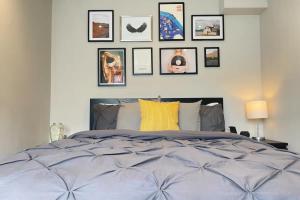 a bedroom with a bed with pictures on the wall at Contemporary 1BD Flat wGarden - Whitechapel in London