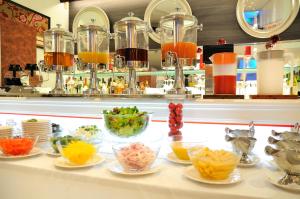 a counter with many bowls of food on a table at Grand Park Hotel Panex Tokyo in Tokyo
