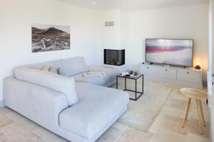 a living room with a white couch and a flat screen tv at Westport in List