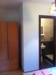 a bathroom with a mirror and a sink at House Pribić in Vrelo Koreničko +63 photos