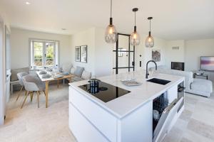 a kitchen and living room with a table and a couch at Westport in List