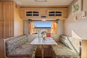a table and chairs in a rv with a table at JT Village Campground - Star Stream in Joshua Tree