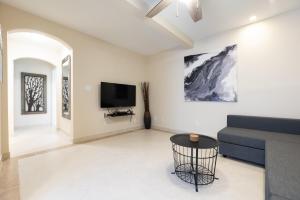 a living room with a couch and a tv at Ocean Flats 1 - Lauderdale-by-the-Sea in Fort Lauderdale