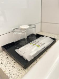 a tray with a napkin and two glasses on a counter at Win Hotel in Sibu