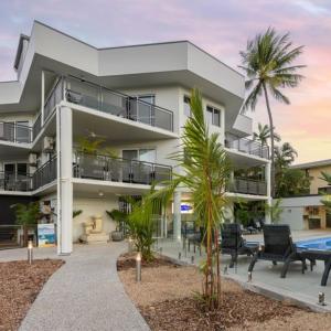a large apartment building with a pool and palm trees at Unit 18 @ Marina Terraces Port Douglas in Port Douglas +19 photos