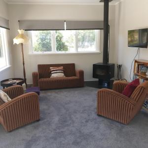 a living room with two couches and a tv at Lavender Row Farm 