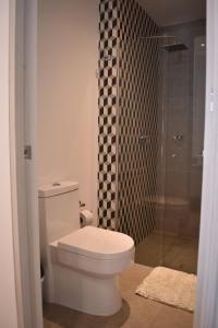 W łazience znajduje się toaleta i przeszklony prysznic. w obiekcie Apartaestudio DISTRITO 90 w mieście Barranquilla