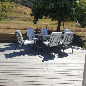 a table and four chairs sitting around a table at Lavender Row Farm in Outram +4 photos