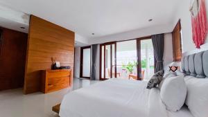 Ein Bett oder Betten in einem Zimmer der Unterkunft Casa Naima Petitenget Villa