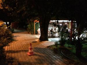 an orange cone on a brick walkway with a tree at Yildiz Pension Bungalows in Cıralı