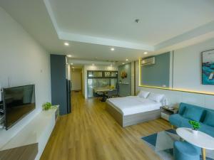 a bedroom with a bed and a couch and a tv at Grand Hyams Hotel - TMS Tầng 21 View Biển Quy Nhơn - 2PN in Quy Nhon