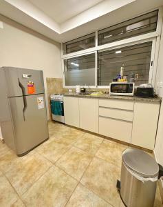 a kitchen with a refrigerator and a microwave at Paramont Rosario 1 in Rosario de la Frontera