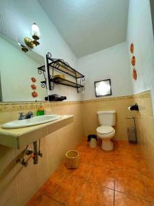 a bathroom with a sink and a toilet at CasaDe Leon-Hotel Boutique in Antigua Guatemala