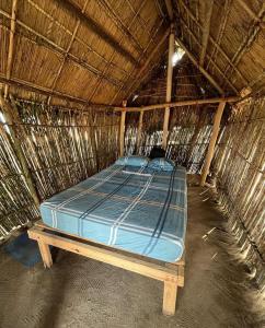 Postel nebo postele na pokoji v ubytování Cabañas tradicionales en isla Aroma