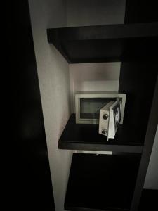 a bathroom with a toilet paper dispenser on a shelf at Gran Hotel Elizabeth in Durango