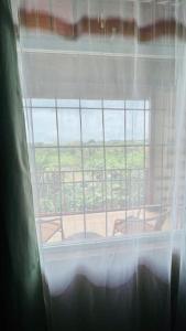 a view of a window with a view of a patio at Beautiful Casa Aire near Lake Arenal in Nuevo Arenal - Casas Airelibre in Nuevo Arenal