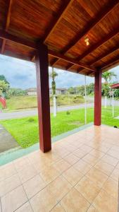 a porch with a roof with a view of a yard at Beautiful Casa Aire near Lake Arenal in Nuevo Arenal - Casas Airelibre in Nuevo Arenal