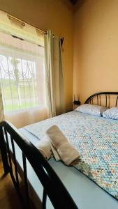 een bed in een kamer met een raam en een bed sidx sidx sidx bij Beautiful Casa Aire near Lake Arenal in Nuevo Arenal - Casas Airelibre in Nuevo Arenal