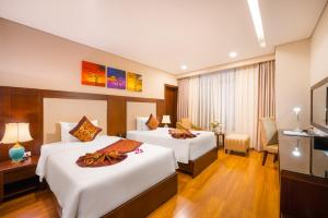 Postelja oz. postelje v sobi nastanitve Minh Toan Galaxy Hotel