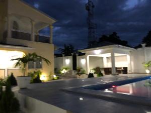 a house with a swimming pool at night at villa piscine timbamba in Pointe-Noire