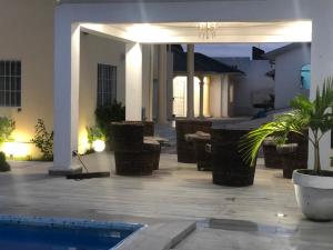 a house with a swimming pool and a patio at villa piscine timbamba in Pointe-Noire