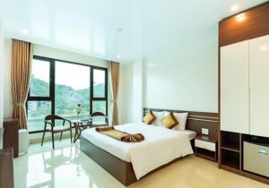 a bedroom with a large bed and a dining room at Tung Quang Hotel in Cat Ba