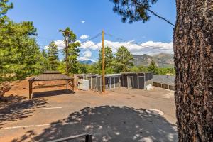 a picnic table in a parking lot next to a tree at Venture at Route 66 in Flagstaff