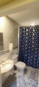 a bathroom with a white toilet and a sink at Taguato Recoleta in Asunción +31 photos