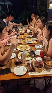 a group of people sitting at a table eating food at Tipolo Beach Resort in Moalboal